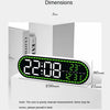 A digital wall clock displaying 22:08, temperature, and date, shown next to a box for size reference.