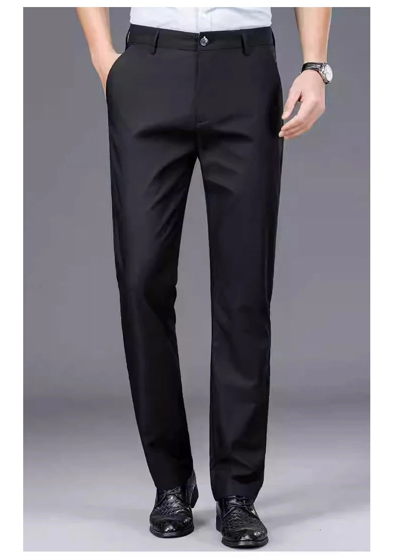 Black men's stretch straight-leg trousers worn by a man, paired with a white shirt and a silver watch.