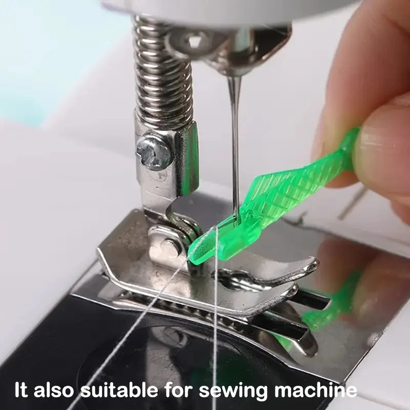 A hand is using an auto needle threader tool to thread a green thread onto a sewing machine needle.
