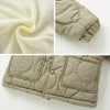 Close-up view of a beige quilted winter jacket with a soft fleece lining and diamond stitching.