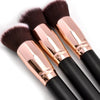 A pair of professional makeup brushes with pink gold handles and dark bristles for foundation, concealer, and blush applicati