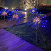 Colorful LED fireworks display in the night featuring bright blue and pink sparks shooting into the air.