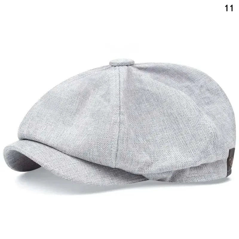 A light gray vintage newsboy cap with a folded brim shown from the side.
