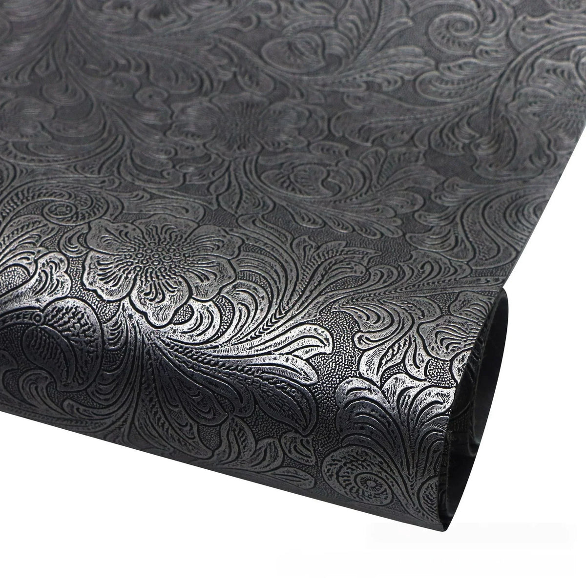 Roll of black faux leather fabric with silver floral texture for crafting projects
