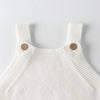 White knitted baby romper with ribbed trim and wooden buttons