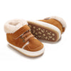 A pair of brown suede baby winter snow boots with fluffy cream-colored shearling lining and a white sole.