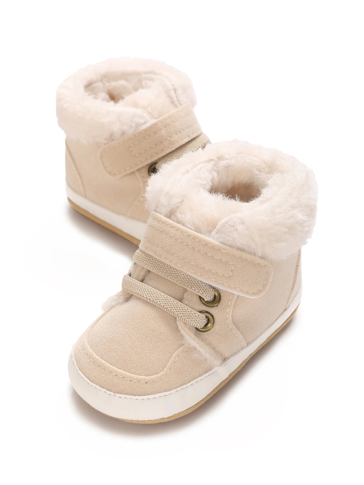 A pair of beige, shearling-lined baby winter snow boots for toddlers.