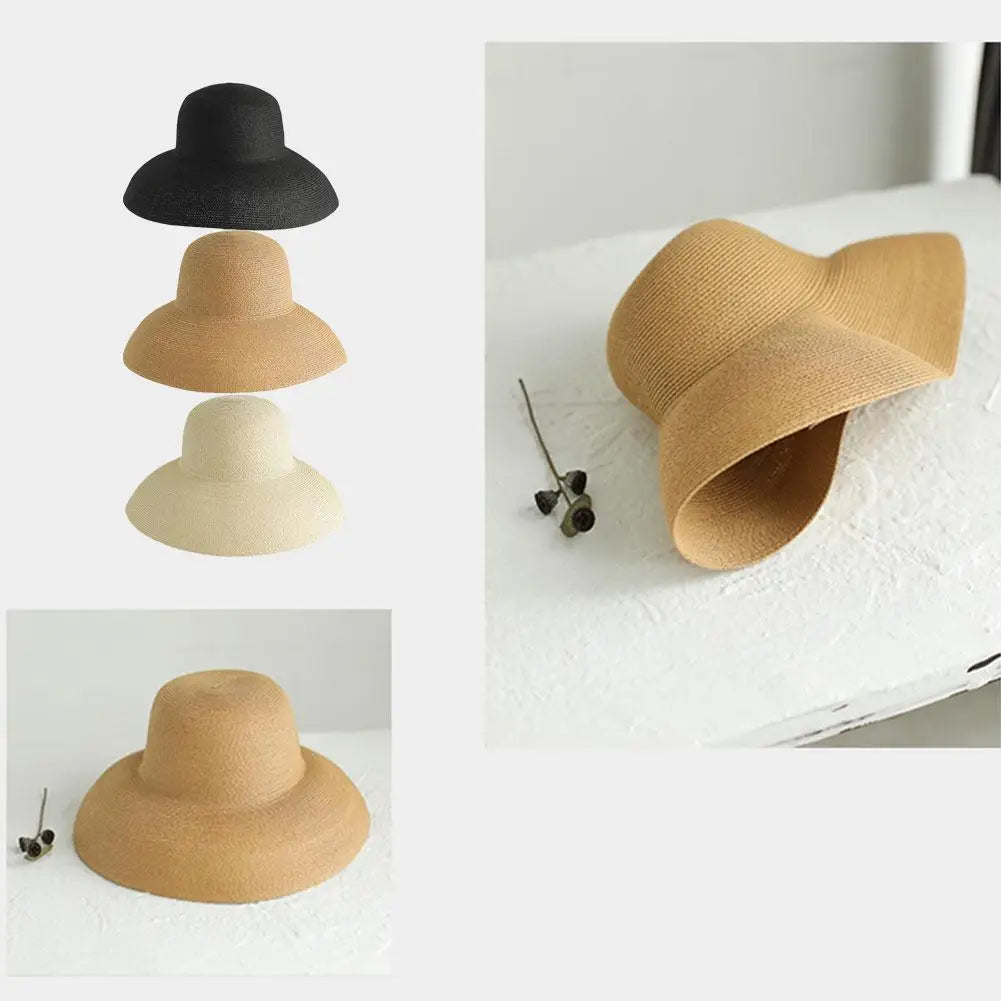 A set of three wide brim straw sun hats in varying shades of beige and black.