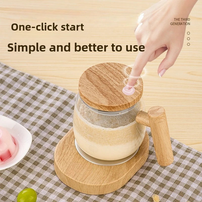 A hand is using a one-click start self-stirring mug with a wooden handle to mix a beverage.