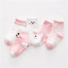 A set of pink and white striped cotton baby socks laid out on a white background.
