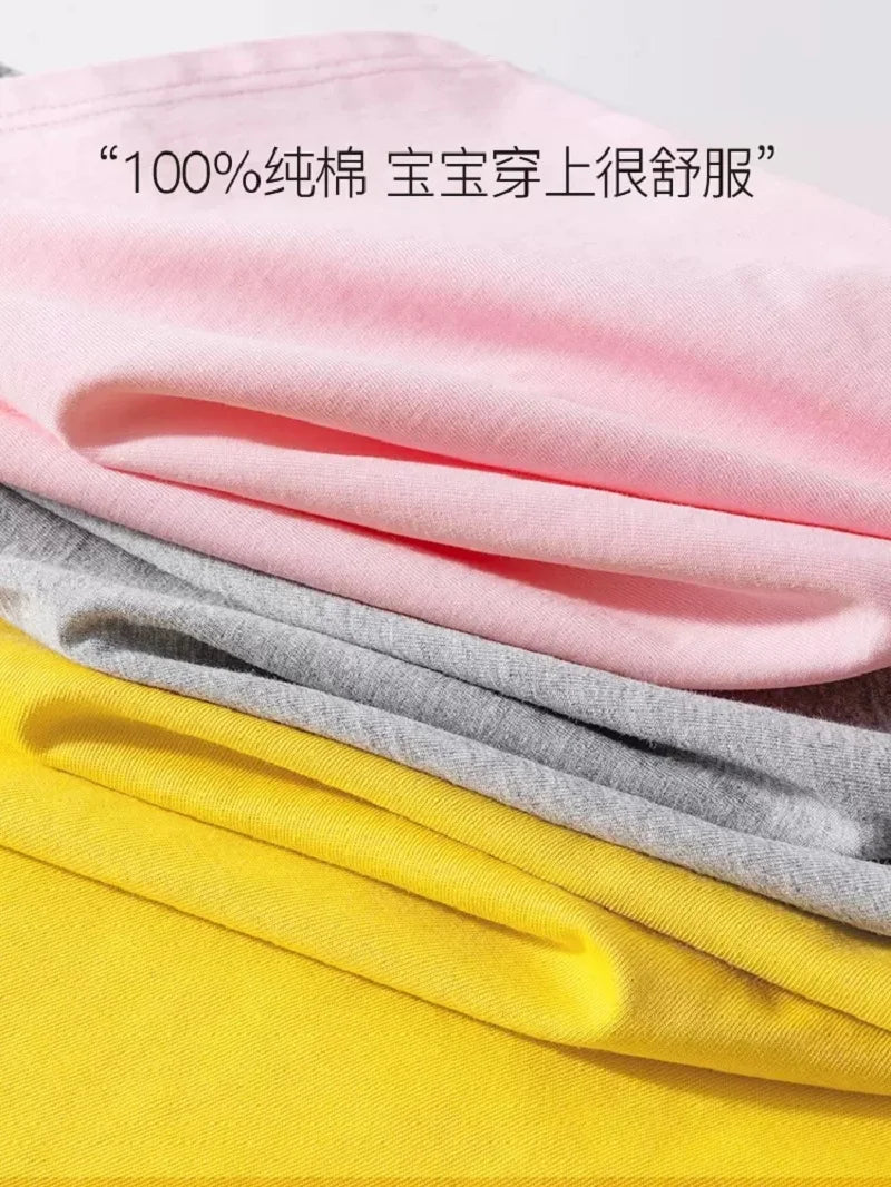 Stacked pink, gray, and yellow children's t-shirts folded together