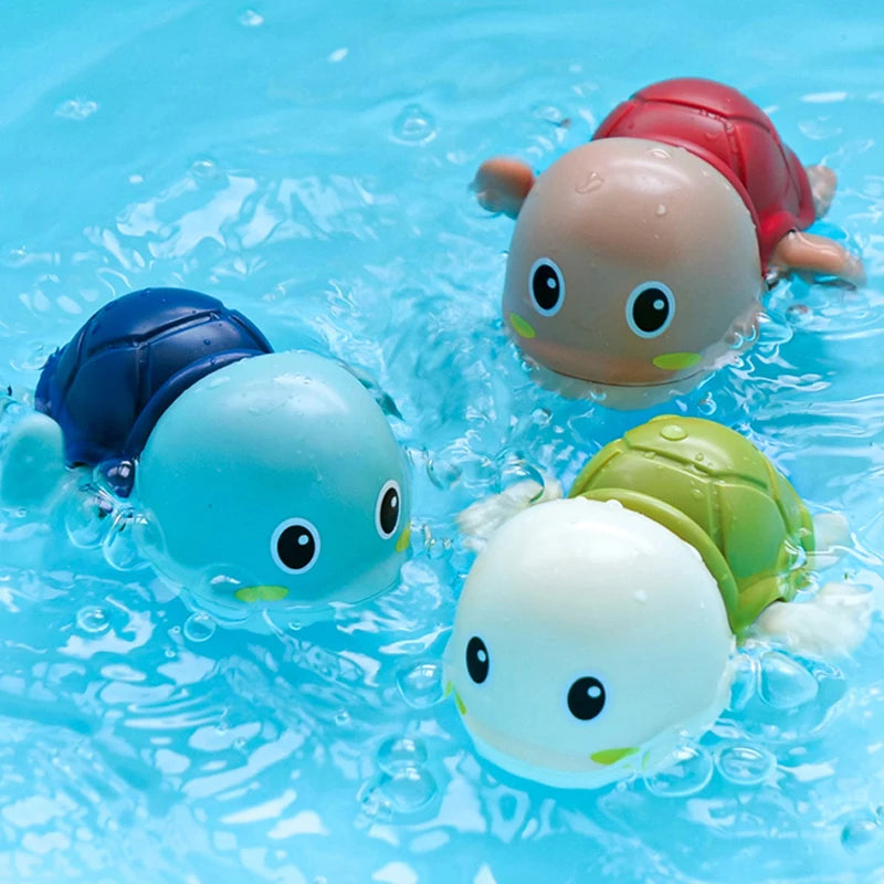 Three bath toys shaped like ducks and penguins floating in blue water.