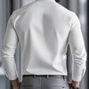 A man wearing a white long-sleeve formal shirt and gray trousers, viewed from the back.