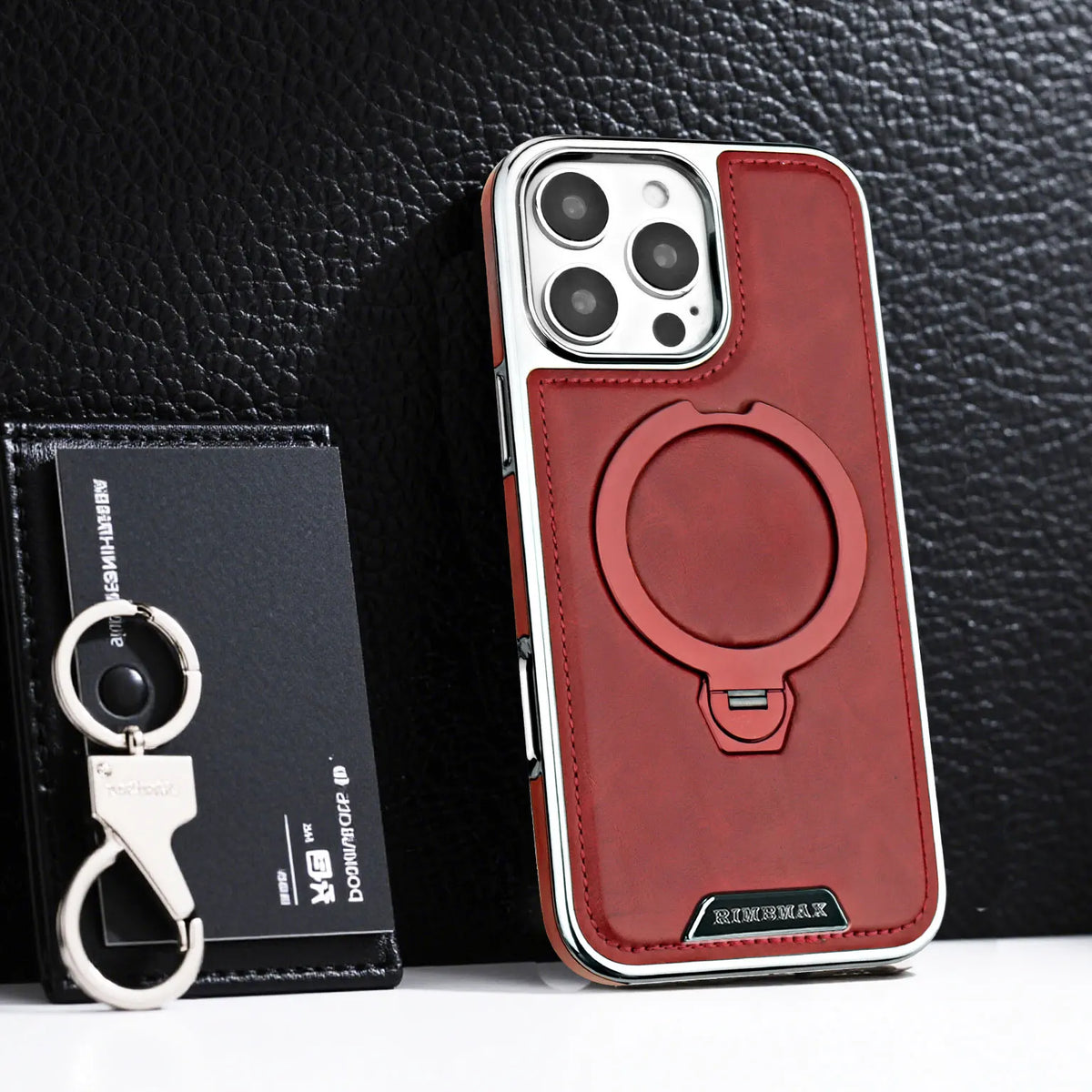 A maroon leather case with a magnetic stand is shown next to an iPhone.