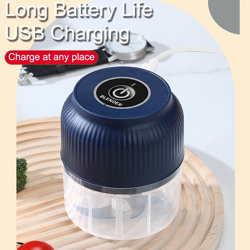 A blue blender jar with a clear lid is shown next to a USB charging cable and a wooden cutting board.
