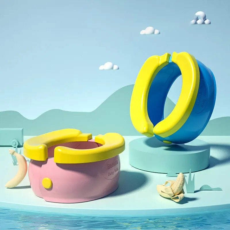 A pink foldable travel potty for kids is shown floating on water, with a yellow waste bag nearby.