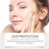 A woman applying SPF 50+ liquid foundation to her face, demonstrating sun protection.