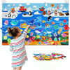 A child interacts with a felt story board featuring various zoo animals and scenes.