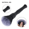 A black detailing brush with a handle and a dense, soft brush head is shown alongside an inset of the brush tip.