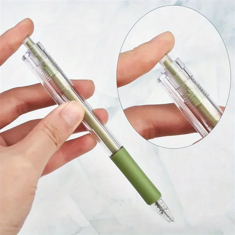 A hand holds a green pen-style utility cutter, showing both the full product and a close-up view.