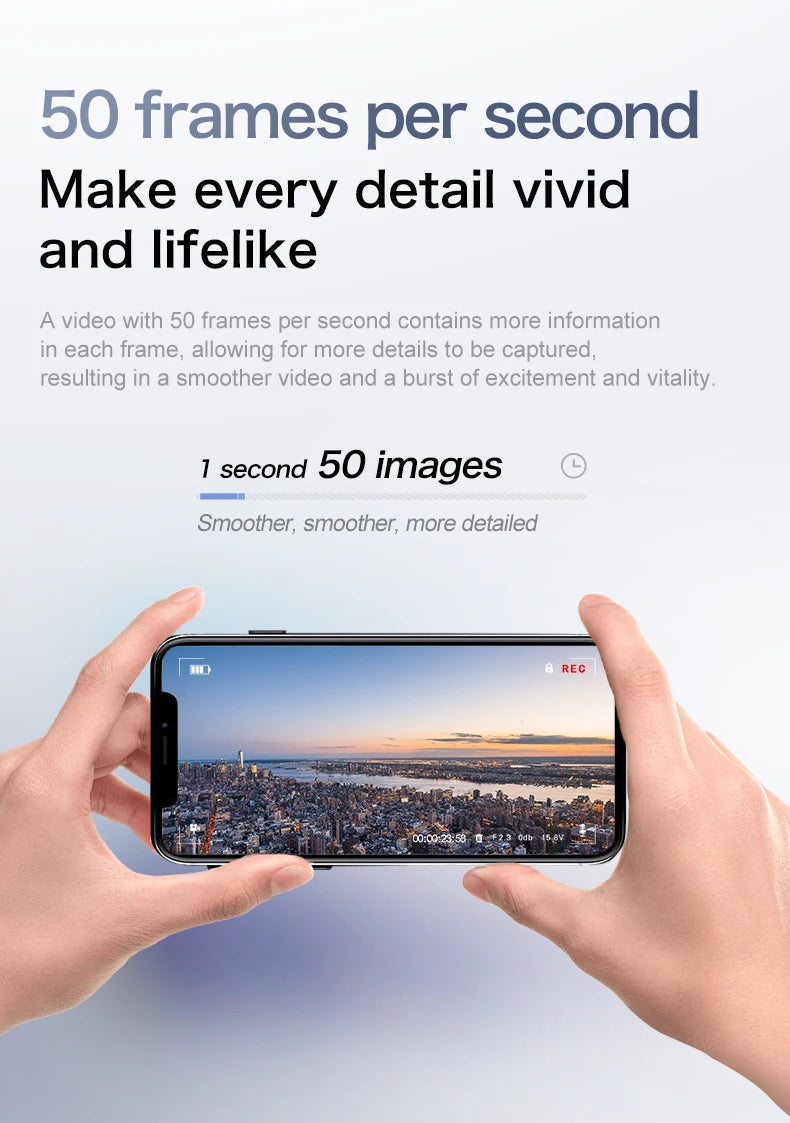 A hand holds a smartphone displaying a panoramic cityscape at sunset.