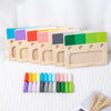A set of wooden color matching puzzles for kids in various pastel and bright colors arranged in a row.