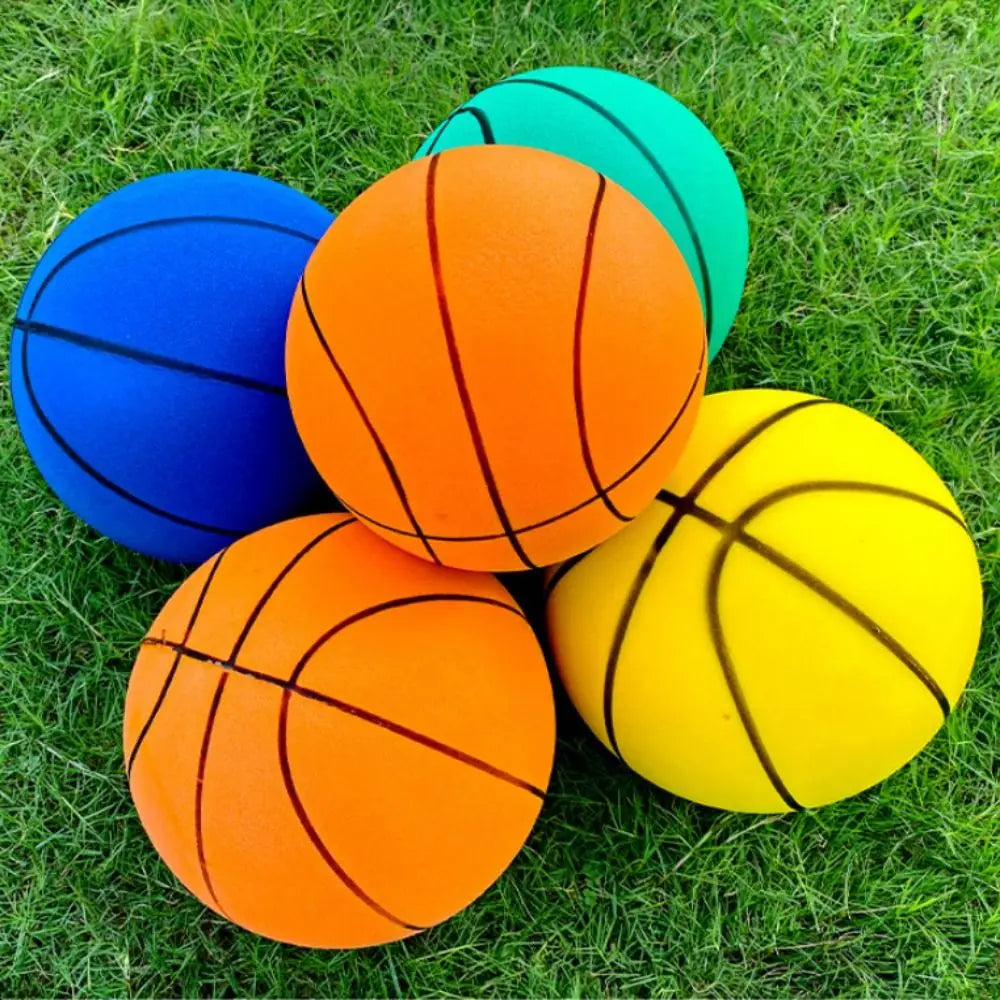 A collection of brightly colored basketballs, including blue, orange, and yellow, resting on green grass.