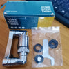 A package and a clear plastic bag containing a metal rotating faucet sprayer head with dual flow modes.