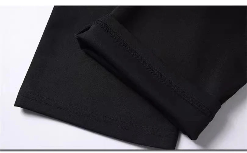 Black men's stretch straight-leg trousers folded and displayed on a white surface.