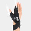 A hand wearing black LED fingerless gloves with a built-in flashlight, demonstrating the light beam.