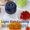 A collection of fresh ingredients like ginger, garlic, onion, and pepper are shown next to a dark blender jar.
