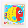 A colorful wooden puzzle featuring a bright yellow and red fish with purple accents.