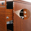 Close-up of a wooden cabinet door with silicone door stopper bumpers installed on the edge.