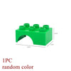 A single green marble run building block with tracks and funnels.