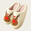 A pair of white, fuzzy winter slippers shaped like reindeer heads with brown accents and pink lining.