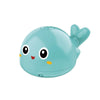 A light blue musical whale bath toy with a smiling face and a flipper.