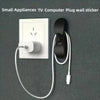 A white plug wall sticker and a black silicone cord winder with a white cord, shown against a dark gray background.