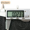 A digital caliper measures 0.023 inches on a vintage floral textured faux leather fabric.