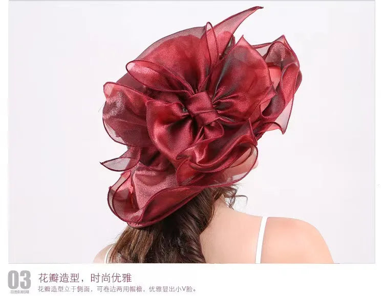 A deep red satin flower-shaped headpiece or fascinator worn on a person's hair.