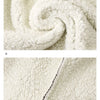 Close-up texture of white fleece fabric with a visible seam detail.