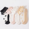 A pack of three lace ruffle ankle socks for baby girls in various pastel colors including pink, white, and beige.