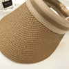 A close-up view of a woven straw sun hat with a wide brim in a natural beige color.