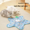 A blue patterned cat toy is shown with a white cat lying nearby, demonstrating a motion-activated hide and seek toy.