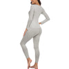 A woman wearing a long-sleeved thermal top and matching leggings in gray.