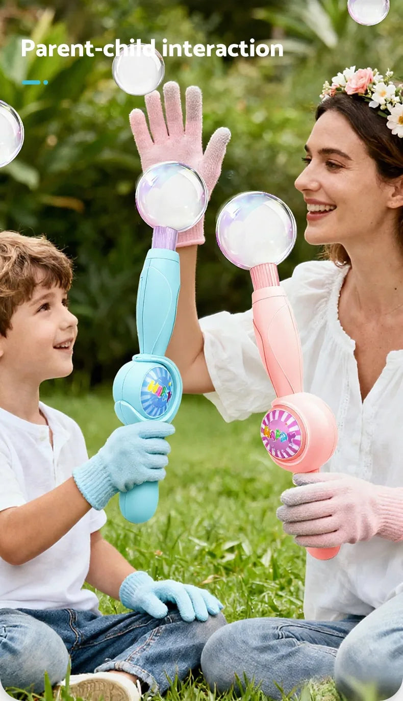 A parent and child interact by blowing bubbles using a pink smoke bubble wand with LED lights in a grassy outdoor setting.