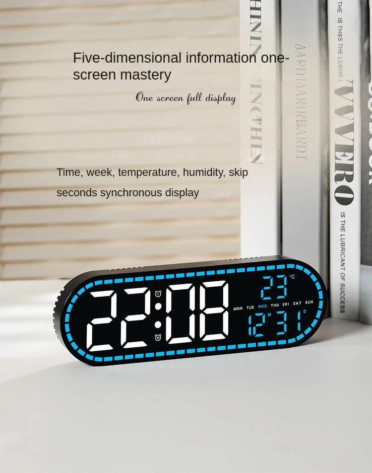 A black digital wall clock displaying the time 22:08, temperature 28°C, and date information.