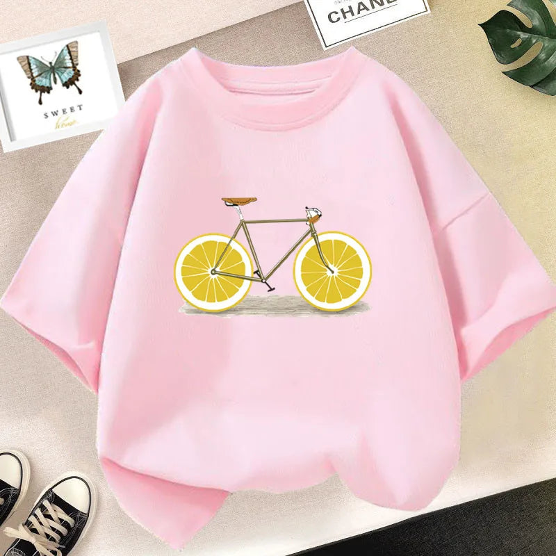 Pink kids t-shirt featuring a graphic print of a bicycle with lemon wheels