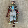 Handcrafted kitchen witch doll with antique charm wearing a layered dress and crown