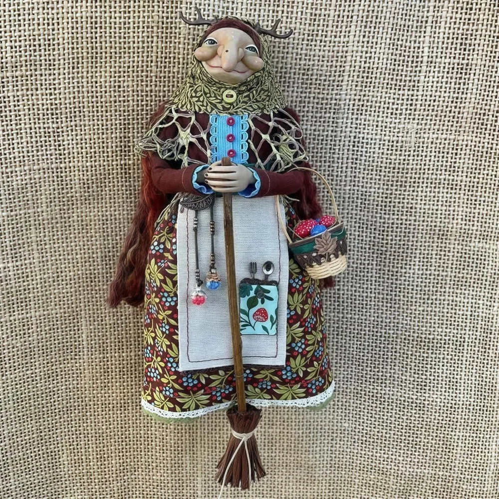 Handcrafted kitchen witch doll with antique charm wearing a layered dress and crown