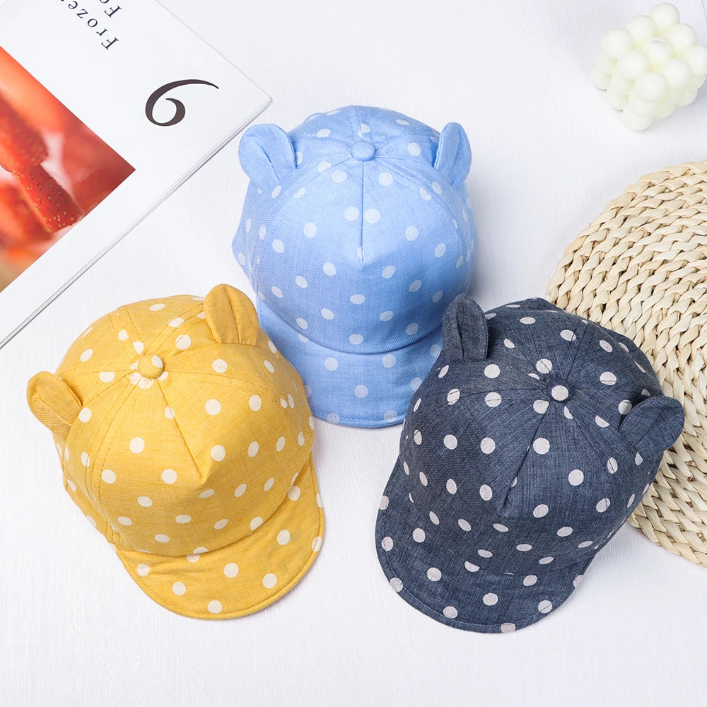 Three toddler sun hats with rabbit ears in blue, yellow, and navy cotton fabric